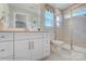 Bright bathroom featuring a large vanity, a walk-in shower, and tile floors at 5666 Stafford Rd # 9, Charlotte, NC 28054