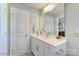 Bright bathroom featuring a sleek vanity with a modern faucet and a large mirror at 5666 Stafford Rd # 9, Charlotte, NC 28054