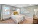 This bedroom boasts a plush bed, bright windows and stylish decor for a modern, cozy feel at 5666 Stafford Rd # 9, Charlotte, NC 28054