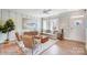 Bright living room featuring stylish decor, a modern ceiling fan, and abundant natural light at 5666 Stafford Rd # 9, Charlotte, NC 28054