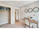 Bright office space features neutral walls, a wood desk with silver lamp, and 3 black analog clocks adorn wall at 5666 Stafford Rd # 9, Charlotte, NC 28054