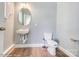Small powder room featuring a white toilet and floating sink at 5666 Stafford Rd # 9, Charlotte, NC 28054