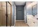 Bathroom featuring a shower, vanity, and linen storage at 5951 Carrollton Ln, Charlotte, NC 28210