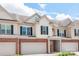 Inviting townhome featuring brick accents, an attached garage, and a covered front entry at 5951 Carrollton Ln, Charlotte, NC 28210