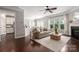 Bright living room with dark wood floors, a fireplace, and an open concept design at 5951 Carrollton Ln, Charlotte, NC 28210