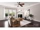 Comfortable living room featuring a fireplace, a large window, and neutral décor at 5951 Carrollton Ln, Charlotte, NC 28210