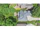 An aerial view shows the home, backyard patio, mature landscaping, driveway and surrounding neighborhood at 6132 Sharon Rd, Charlotte, NC 28210