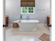 Elegant bathroom showcasing a standalone tub and bright window at 6132 Sharon Rd, Charlotte, NC 28210