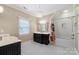 A bright bathroom with a black-and-white tiled floor, dual sinks, and a shower tub at 6132 Sharon Rd, Charlotte, NC 28210