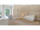 A bedroom with a daybed, desk and a window provides a serene space for rest and productivity at 6132 Sharon Rd, Charlotte, NC 28210