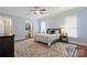 Comfortable bedroom with hardwood floors, ceiling fan, and a walk-in closet at 6132 Sharon Rd, Charlotte, NC 28210