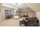 A cozy bonus room features comfortable seating, a TV, and a table for Gathering entertainment at 6132 Sharon Rd, Charlotte, NC 28210