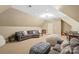 A spacious bonus room with cozy seating and a music corner provides space to relax and unwind at 6132 Sharon Rd, Charlotte, NC 28210