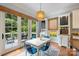 Bright dining area featuring hardwood floors, stylish lighting, and access to an outdoor patio at 6132 Sharon Rd, Charlotte, NC 28210