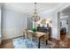 Bright dining room with a chandelier, seating for six, and hardwood floors at 6132 Sharon Rd, Charlotte, NC 28210