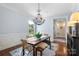 Elegant dining room featuring a chandelier, wainscoting, and hardwood floors at 6132 Sharon Rd, Charlotte, NC 28210