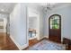 Inviting entryway with hardwood floors, arched wood door, and chandelier at 6132 Sharon Rd, Charlotte, NC 28210