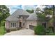 Beautiful brick and stone home featuring a two car garage and a well manicured lawn at 6132 Sharon Rd, Charlotte, NC 28210