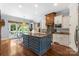 Gourmet kitchen featuring a blue island, white cabinets, and a cozy breakfast nook at 6132 Sharon Rd, Charlotte, NC 28210