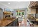 Well-appointed kitchen featuring a large island, modern appliances, and fireplace at 6132 Sharon Rd, Charlotte, NC 28210
