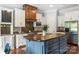 Stylish kitchen with stainless steel appliances, a blue island, and custom cabinetry at 6132 Sharon Rd, Charlotte, NC 28210