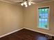 Bedroom featuring wood-look flooring, neutral walls, and a ceiling fan with lighting at 7212 Bradley Ct, Charlotte, NC 28227