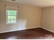 This bedroom has a large window with natural light and sleek wood-look floors at 7212 Bradley Ct, Charlotte, NC 28227