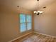 Bright dining room featuring wood floors, a chandelier, and a window providing natural light at 7212 Bradley Ct, Charlotte, NC 28227