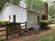 A view of the home's exterior with white siding and a brick chimney at 7212 Bradley Ct, Charlotte, NC 28227