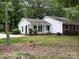 Charming home featuring a well-maintained lawn, a partial brick facade, and eye-catching blue shutters at 7212 Bradley Ct, Charlotte, NC 28227