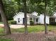 Charming home featuring a well-maintained lawn, a partial brick facade, and eye-catching blue shutters at 7212 Bradley Ct, Charlotte, NC 28227