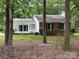 Charming home featuring a well-maintained lawn, a partial brick facade, and eye-catching blue shutters at 7212 Bradley Ct, Charlotte, NC 28227