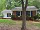 Charming home featuring a well-maintained lawn, a partial brick facade, and eye-catching blue shutters at 7212 Bradley Ct, Charlotte, NC 28227