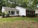 Charming home featuring a well-maintained lawn, a partial brick facade, and eye-catching blue shutters at 7212 Bradley Ct, Charlotte, NC 28227