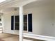 Charming front porch featuring white trim and complementary blue shutters for added curb appeal at 7212 Bradley Ct, Charlotte, NC 28227