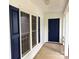 Inviting front porch with classic blue door and matching shutters framing the windows at 7212 Bradley Ct, Charlotte, NC 28227