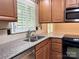 Stylish kitchen showcasing granite countertops, a stainless steel sink, and modern appliances at 7212 Bradley Ct, Charlotte, NC 28227