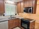 Well-lit kitchen featuring granite countertops, stainless steel appliances, and custom cabinetry at 7212 Bradley Ct, Charlotte, NC 28227