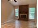 Cozy living room with brick fireplace, mantle, and door to outside at 7212 Bradley Ct, Charlotte, NC 28227