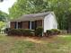 Home featuring brick accents, white siding, a well-maintained lawn, and eye-catching blue shutters at 7212 Bradley Ct, Charlotte, NC 28227