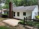 Home featuring brick accents, white siding, a well-maintained lawn, and eye-catching blue shutters at 7212 Bradley Ct, Charlotte, NC 28227