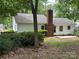 Home featuring brick accents, white siding, a well-maintained lawn, and eye-catching blue shutters at 7212 Bradley Ct, Charlotte, NC 28227