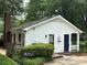 Home featuring brick accents, white siding, a well-maintained lawn, and eye-catching blue shutters at 7212 Bradley Ct, Charlotte, NC 28227