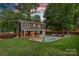 Backyard with a cozy covered patio, in-ground pool and privacy fence at 8007 Maxwelton Dr, Huntersville, NC 28078