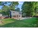 Expansive backyard with a pool, covered patio, and grilling area at 8007 Maxwelton Dr, Huntersville, NC 28078