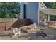 Backyard featuring a stone firepit, adirondack chairs, and gravel groundcover at 8007 Maxwelton Dr, Huntersville, NC 28078