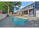 Beautiful backyard with a pool, patio, and lush landscaping at 8007 Maxwelton Dr, Huntersville, NC 28078