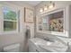 Bright bathroom with a modern vanity, stylish mirror, and a bathtub with a colorful shower curtain at 8007 Maxwelton Dr, Huntersville, NC 28078