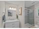 Well-lit bathroom featuring a modern vanity with marble countertop, stylish mirror, and a glass-enclosed shower at 8007 Maxwelton Dr, Huntersville, NC 28078