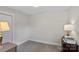 Neutral bedroom with gray carpet, white trim, and vintage-style lamps at 8007 Maxwelton Dr, Huntersville, NC 28078